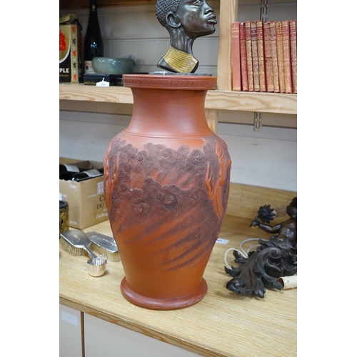 563 - A large Japanese terracotta dragon decorated vase, 50cm high. Condition - hole drilled to base... 