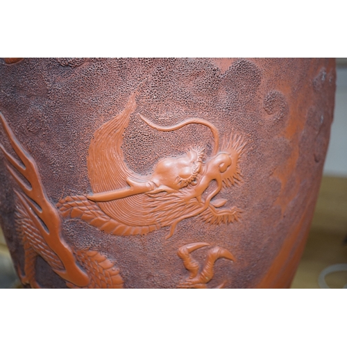 563 - A large Japanese terracotta dragon decorated vase, 50cm high. Condition - hole drilled to base... 