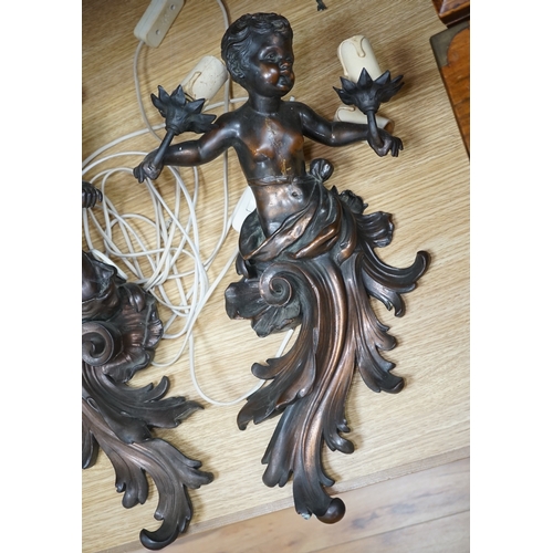 564 - A pair of cast metal caryatid putti two light wall sconces, 45cm high. Condition - poor