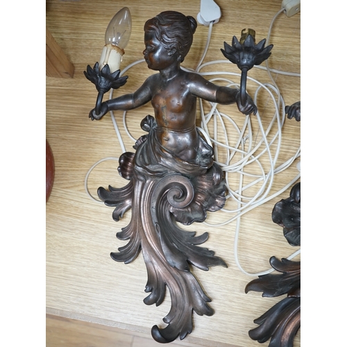 564 - A pair of cast metal caryatid putti two light wall sconces, 45cm high. Condition - poor