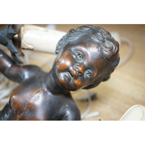 564 - A pair of cast metal caryatid putti two light wall sconces, 45cm high. Condition - poor