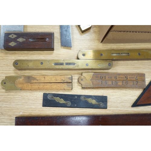 567 - A collection of 19th and 20th century drawing instruments including; levels, rulers, a set square et... 