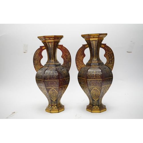 587 - A pair of Venetian Islamic inspired gilt decorated ruby glass twin handled vases, 24cm high. Conditi... 