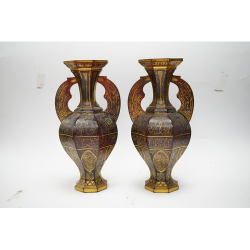 587 - A pair of Venetian Islamic inspired gilt decorated ruby glass twin handled vases, 24cm high. Conditi... 