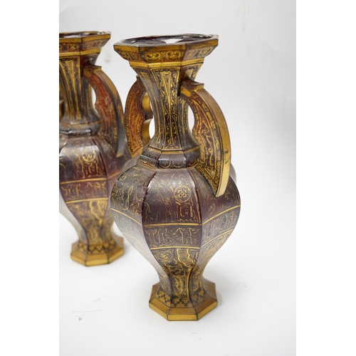 587 - A pair of Venetian Islamic inspired gilt decorated ruby glass twin handled vases, 24cm high. Conditi... 