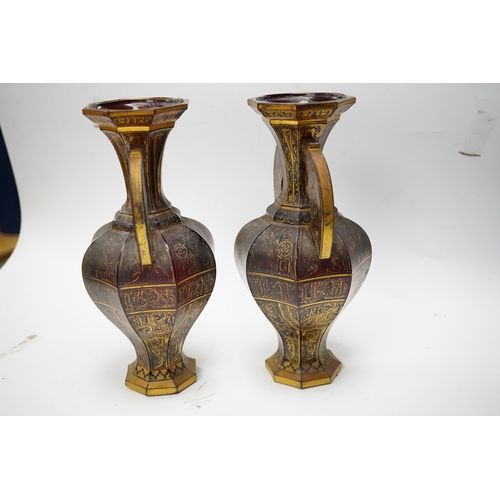 587 - A pair of Venetian Islamic inspired gilt decorated ruby glass twin handled vases, 24cm high. Conditi... 