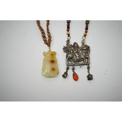 589 - A Chinese celadon and russet jade cicada pendant on cording and a silver and stone mounted chain and... 