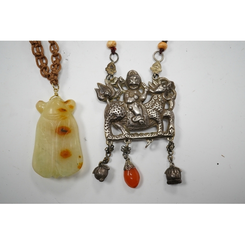 589 - A Chinese celadon and russet jade cicada pendant on cording and a silver and stone mounted chain and... 