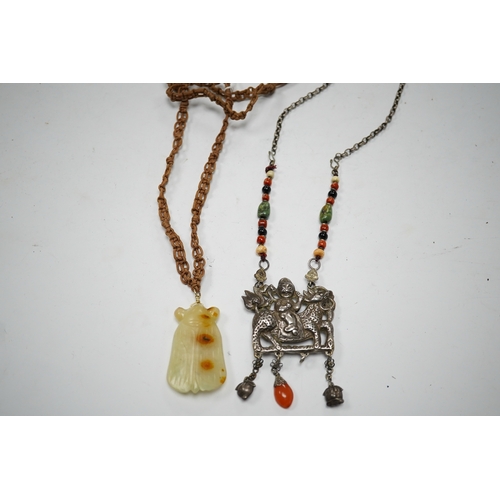 589 - A Chinese celadon and russet jade cicada pendant on cording and a silver and stone mounted chain and... 