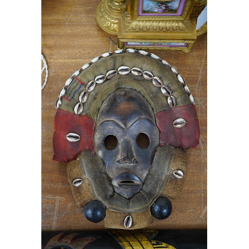 617 - African art - a Liberian/Ivory Coast Dan mask with shell mounts together with another, largest 100cm... 