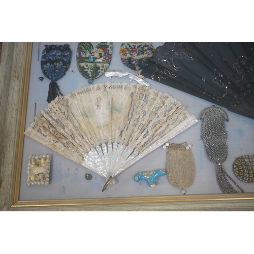 629 - A framed display montage of late 18th and 19th century decorative ladies sequin and lace fans, beadw... 