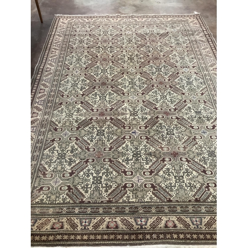 63 - An ivory ground geometric carpet, approx. 290 x 200cm. Condition - fair