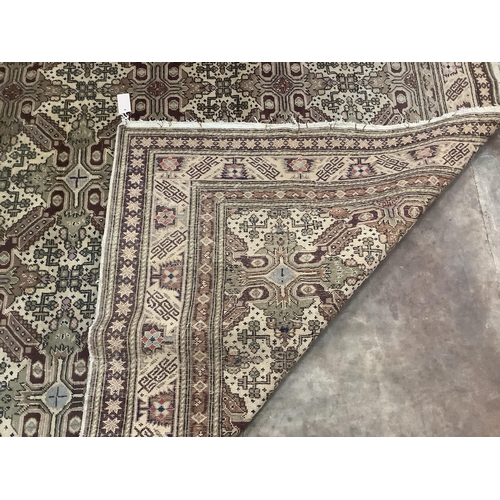 63 - An ivory ground geometric carpet, approx. 290 x 200cm. Condition - fair