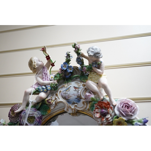 630 - A Meissen style porcelain floral encrusted and figural mirror, 64cm high. Condition - fair, minor lo... 