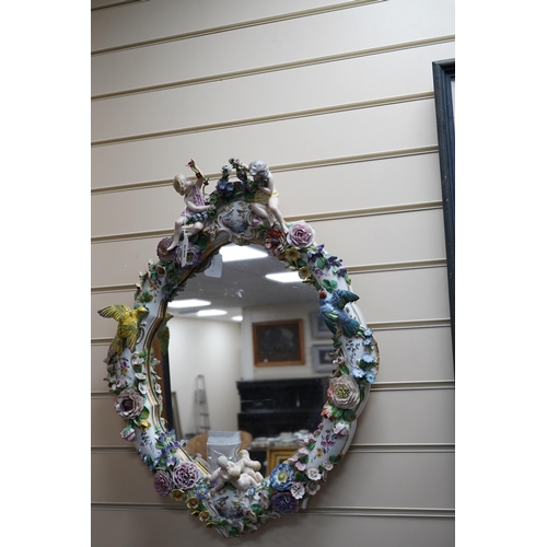 630 - A Meissen style porcelain floral encrusted and figural mirror, 64cm high. Condition - fair, minor lo... 