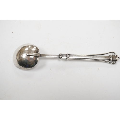 827 - An Edwardian Arts & Crafts silver spoon, by Albert Edward Jones, Birmingham, 1907, 14.3cm. Condition... 