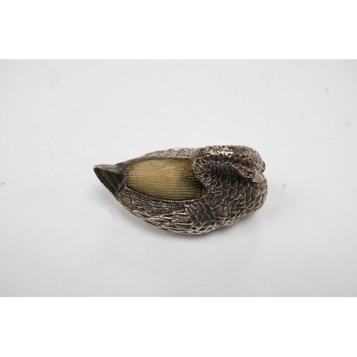 831 - A modern silver mounted swan pin cushion, Ari D Norman, London, 1988, length 59mm. Condition - fair... 