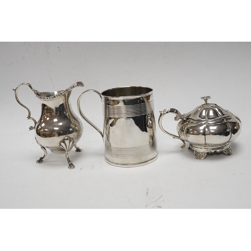 849 - A George III silver cream jug, marks rubbed, a George III silver christening mug, London, 1801 and a... 