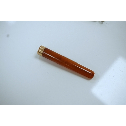 857 - A 9ct gold mounted amber cigarette holder, 78mm, in a silver case. Condition - fair