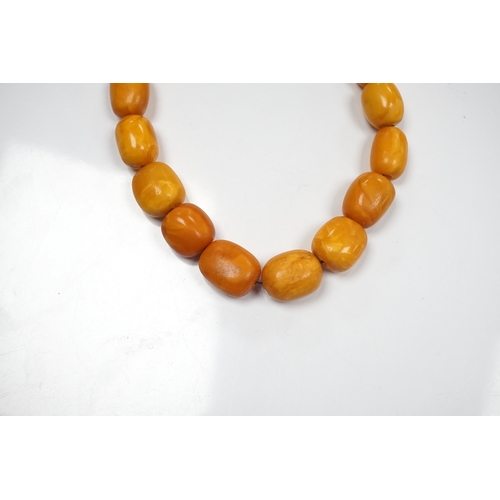 903 - A single strand graduated oval amber bead necklace, 42cm, gross weight 49 grams. Condition - poor to... 