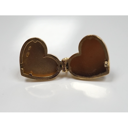 904 - A modern Louis Vuitton 750 yellow metal and garnet? set heart shaped locket, width 15mm, gross weigh... 