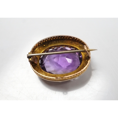 905 - A mid 20th century 9ct and single stone oval cut amethyst set pendant brooch, with seed pearl border... 