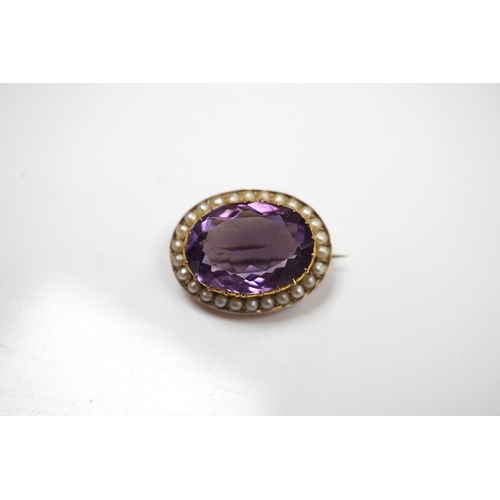 905 - A mid 20th century 9ct and single stone oval cut amethyst set pendant brooch, with seed pearl border... 