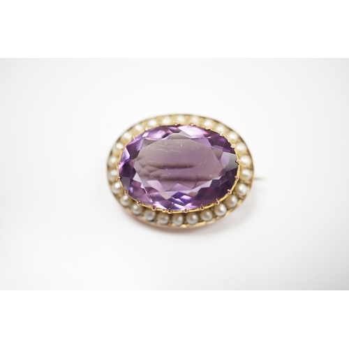 905 - A mid 20th century 9ct and single stone oval cut amethyst set pendant brooch, with seed pearl border... 