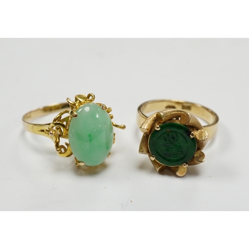 911 - A Chinese 14k and single stone oval cabochon jadeite set ring, size P and a similar 14k and spinach ... 