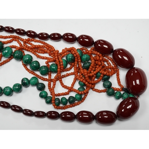 923 - A graduated simulated cherry amber bead necklace, 43cm, gross weight 54 grams and two other necklace... 