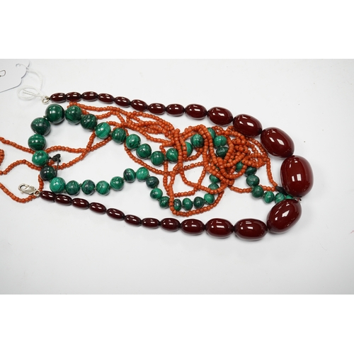 923 - A graduated simulated cherry amber bead necklace, 43cm, gross weight 54 grams and two other necklace... 