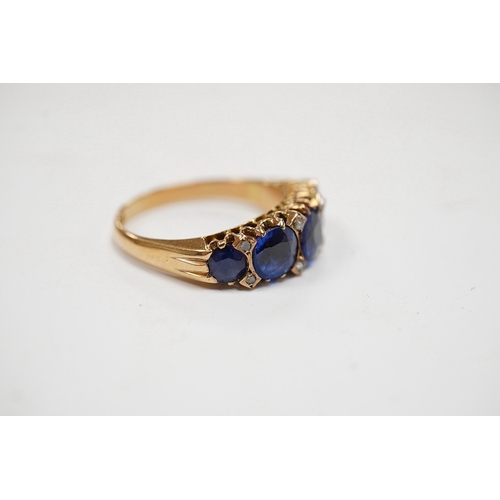 927 - An 18ct and graduated five stone blue doublet set half hoop ring, with diamond chip spacers, size L,... 