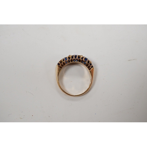 927 - An 18ct and graduated five stone blue doublet set half hoop ring, with diamond chip spacers, size L,... 