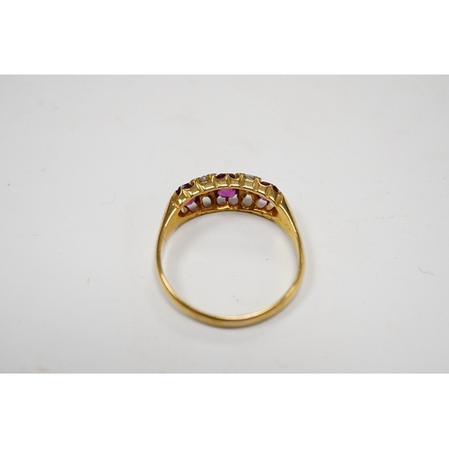 931 - A late Victorian 18ct gold and three stone ruby set half hoop ring, with four stone diamond chip spa... 