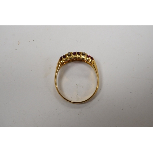 931 - A late Victorian 18ct gold and three stone ruby set half hoop ring, with four stone diamond chip spa... 