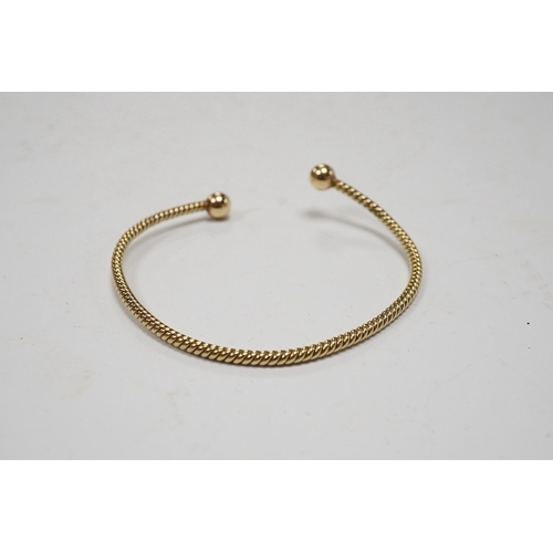 939 - A modern 9ct gold open work bangle, with spherical terminals, 8.4 grams. Condition - fair