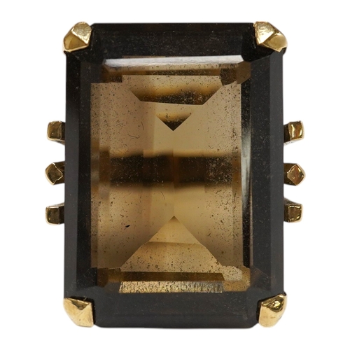 944 - A 9ct and large single stone emerald cut smoky quartz set dress ring, size P, gross weight 14.9 gram... 