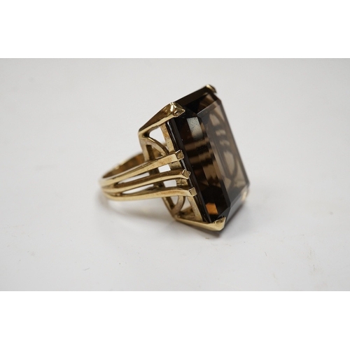 944 - A 9ct and large single stone emerald cut smoky quartz set dress ring, size P, gross weight 14.9 gram... 