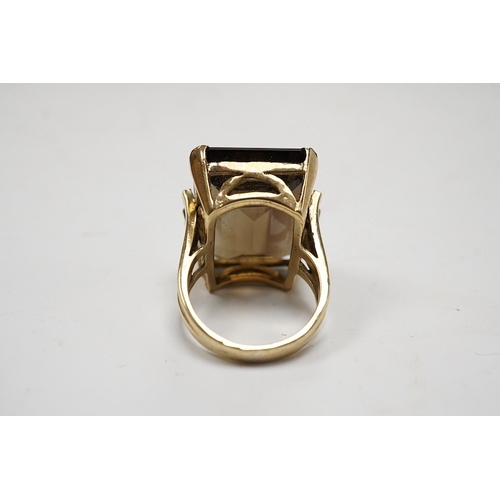 944 - A 9ct and large single stone emerald cut smoky quartz set dress ring, size P, gross weight 14.9 gram... 