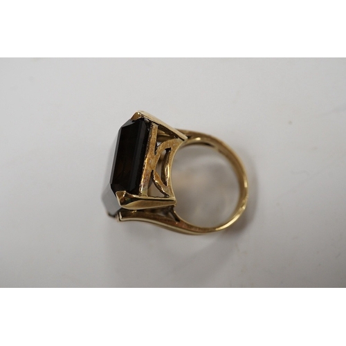 944 - A 9ct and large single stone emerald cut smoky quartz set dress ring, size P, gross weight 14.9 gram... 