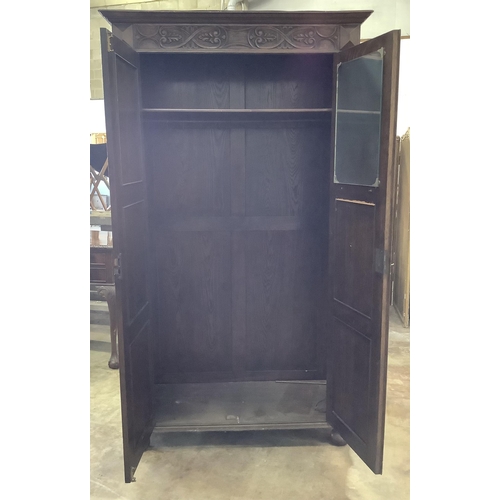 1004 - A 17th century style carved oak wardrobe, width 112cm, depth 46cm, height 197cm. Condition - fair... 