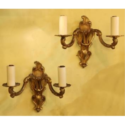 1064 - A pair of late 19th century French ormolu twin branch wall lights, 21cm high. Condition - fair to go... 