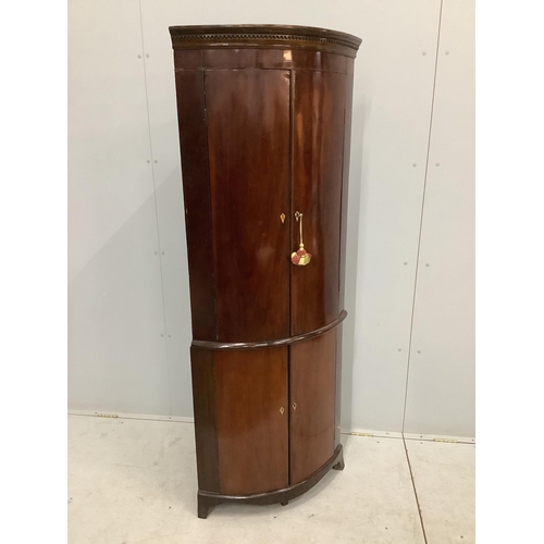 1107 - A George III mahogany bow front corner cupboard on later base, width 70cm, depth 46cm, height 179cm.... 