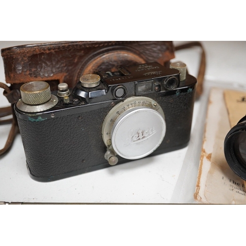 1252 - A Leica Model II camera in leather case, together with an Elmar 4.5/135mm lens, lens table booklet a... 