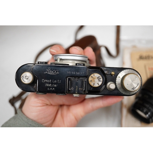 1252 - A Leica Model II camera in leather case, together with an Elmar 4.5/135mm lens, lens table booklet a... 