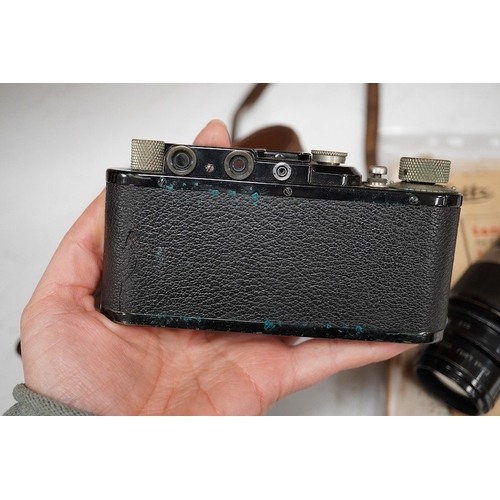 1252 - A Leica Model II camera in leather case, together with an Elmar 4.5/135mm lens, lens table booklet a... 