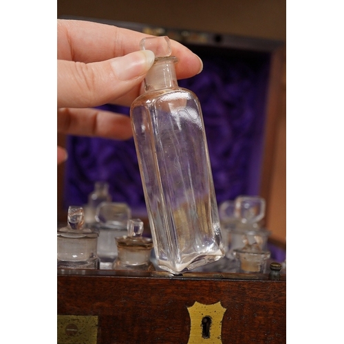 1254 - An early 19th century mahogany apothecary box, containing ten glass bottles, one with original paper... 