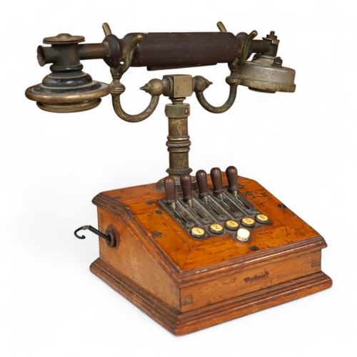 1255 - An early 20th century mahogany cased telephone, possibly by Ericsson, with handset on decorative cra... 