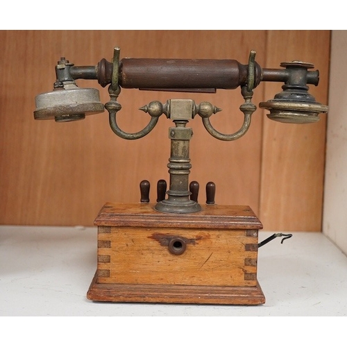 1255 - An early 20th century mahogany cased telephone, possibly by Ericsson, with handset on decorative cra... 