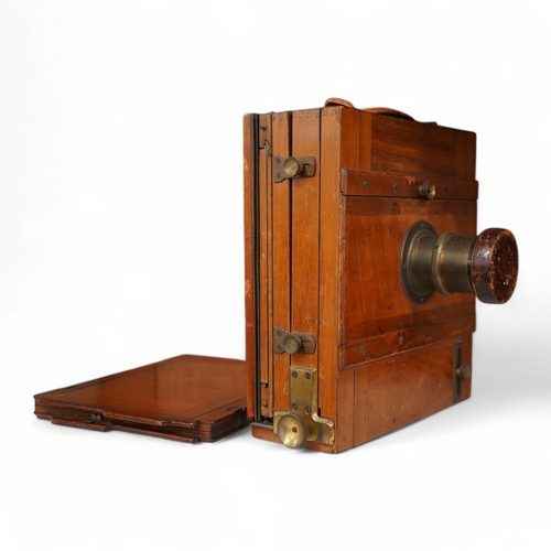 1256 - An early 20th century brass mounted mahogany full plate camera, together with a glass negative holde... 